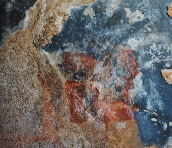 Fig. 70. A counterclockwise swastika partially carved over a portion of a raw stone surface.