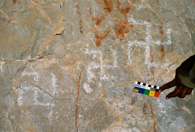 Fig. 82. Three white counterclockwise swastikas of the Vestigial period in the same cave sanctuary as fig. 38.