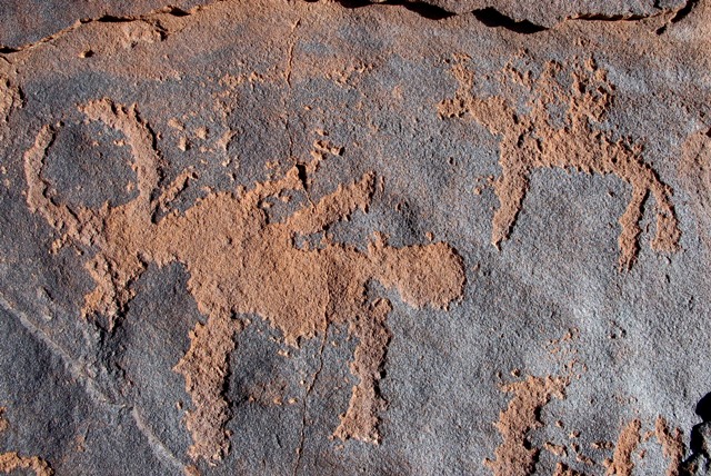 Fig. 20: An archer mounted on a horse taking aim at a wild yak. The yak has already been hit in the back by three projectiles. Iron Age.