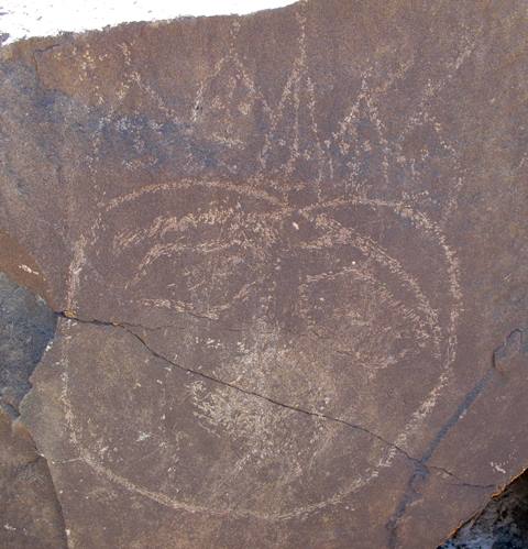 Fig. 29: An anthropomorphic head crudely carved in shallow relief. Early Historic period or Vestigial period. 