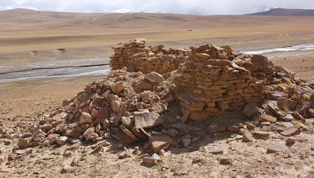 Fig. 35. The temple-tomb and recently vandalized east wall, Central Complex. Much of the east wall was destroyed by excavation. Several tons of rubble were removed from the interior of the edifice by grave robbers. The river running through the valley hugs the base of the esplanade below the Central Complex.