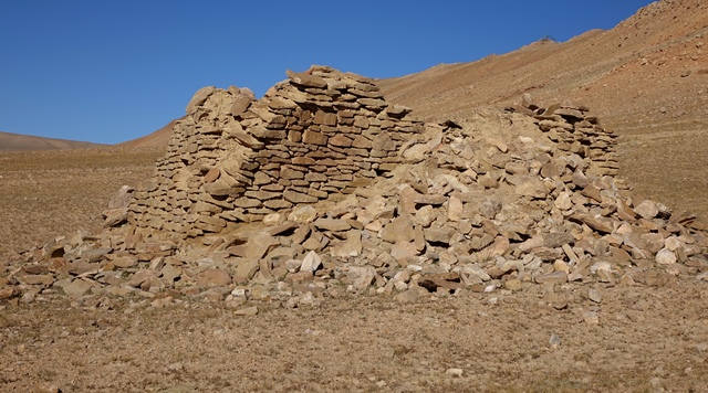 Fig. 36. The east and south walls of the temple-tomb, Central Complex. The rubble piled against the structure came from the destroyed portion of the east wall and the interior of the edifice.