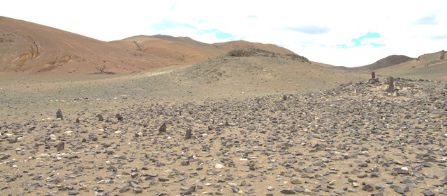 Fig. 23. The array of pillars and appended temple-tomb taken from the south. 