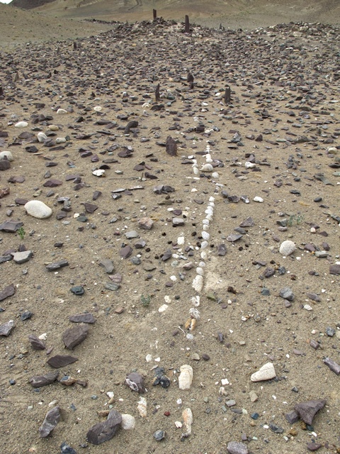 Fig. 26. A wall consisting of two parallel courses of cobbles lodged in the ground, which cuts through the array of stelae and continues beyond its southeast extent. This type of wall did not support a superstructure, rather it appears to have had a peculiar ritualistic function. Double-course walls interspersed in a concourse of standing stones are quite common at stelar necropolises (they are often made of slabs set edgewise into the ground).