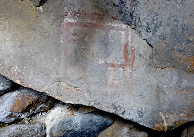 Fig. 17. Bichrome pictograph painted on rear wall of cave on the edge of the bench. This subject consists of a rectangular form, the bottom part of which has been largely obliterated. It is subdivided into at least five quadrate sections. The red lines of this pictograph are paralleled inside and out by thinner white lines.