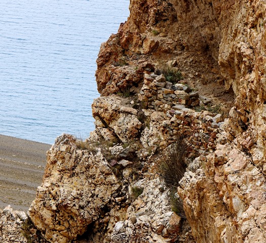 Fig. 20. Another view of the inaccessible rock shelter, rising 200 m above the waters of Lake Dangra.