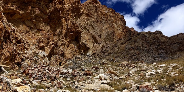 Fig. 23. A view of the upper residential complex of Gondak as seen from the slope below. On the lower left side of the photograph are the remains of a revetment, the lowest structure of the complex. Above the revetment, on the slope along the edge of the rocky formation, are the various structures of the site.