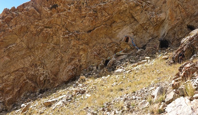 Fig. 25. The main concentration of ruins in the upper complex. On the extreme upper right is a small cave depository for clay figurines. Below it and to the left are caves flanking the upper sector of the site. The cave and ruins in the middle of the image belong to the middle sector, while the more open area downhill is the lower sector. The ruin on the lower left side of the photo is the largest single extant structure at Gondak.