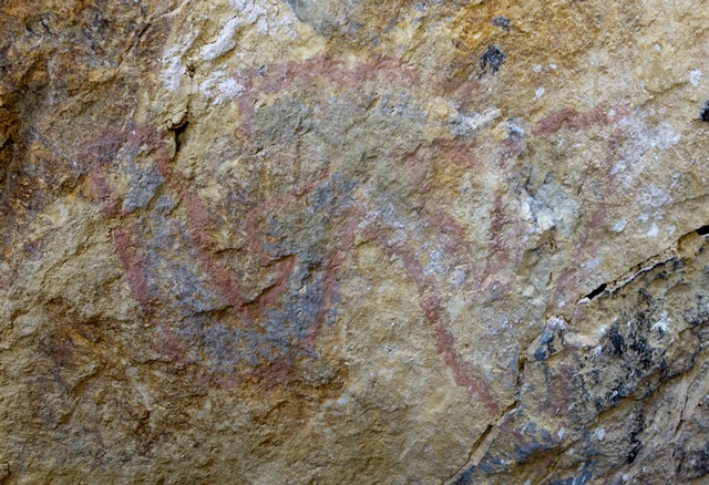 Fig. 32. A letter A on the rear wall of the cave pictured in fig. 30. This letter was skillfully written using red and white pigments.