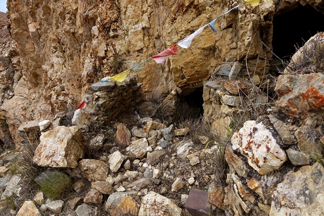 Fig. 35. Remains of the west room of the middle tier of the upper residential complex. In the center of the photograph is the entrance to the adjoining cave. In the middle foreground a reddish corbel juts out from the rear wall. Only small fragments of the forward wall of the room have endured.