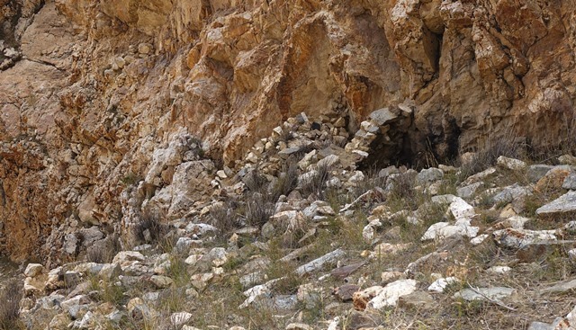 Fig. 43. Two of the most prominent structures of the lower tier, upper residential complex. A room built into the formation is on the middle right side of the photograph. The structure to its left contains the only intact entranceway in an archaic era building of the site.