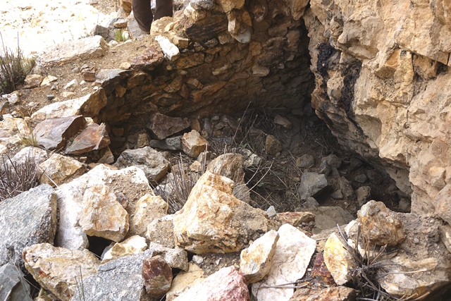 Fig. 44. Room built in a recess in the formation, lower tier. The remains of corbelling that once encircled the top of the walls are visible.